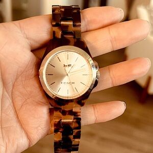 A beautiful Coach women’s watch with a tortoise shell band.
